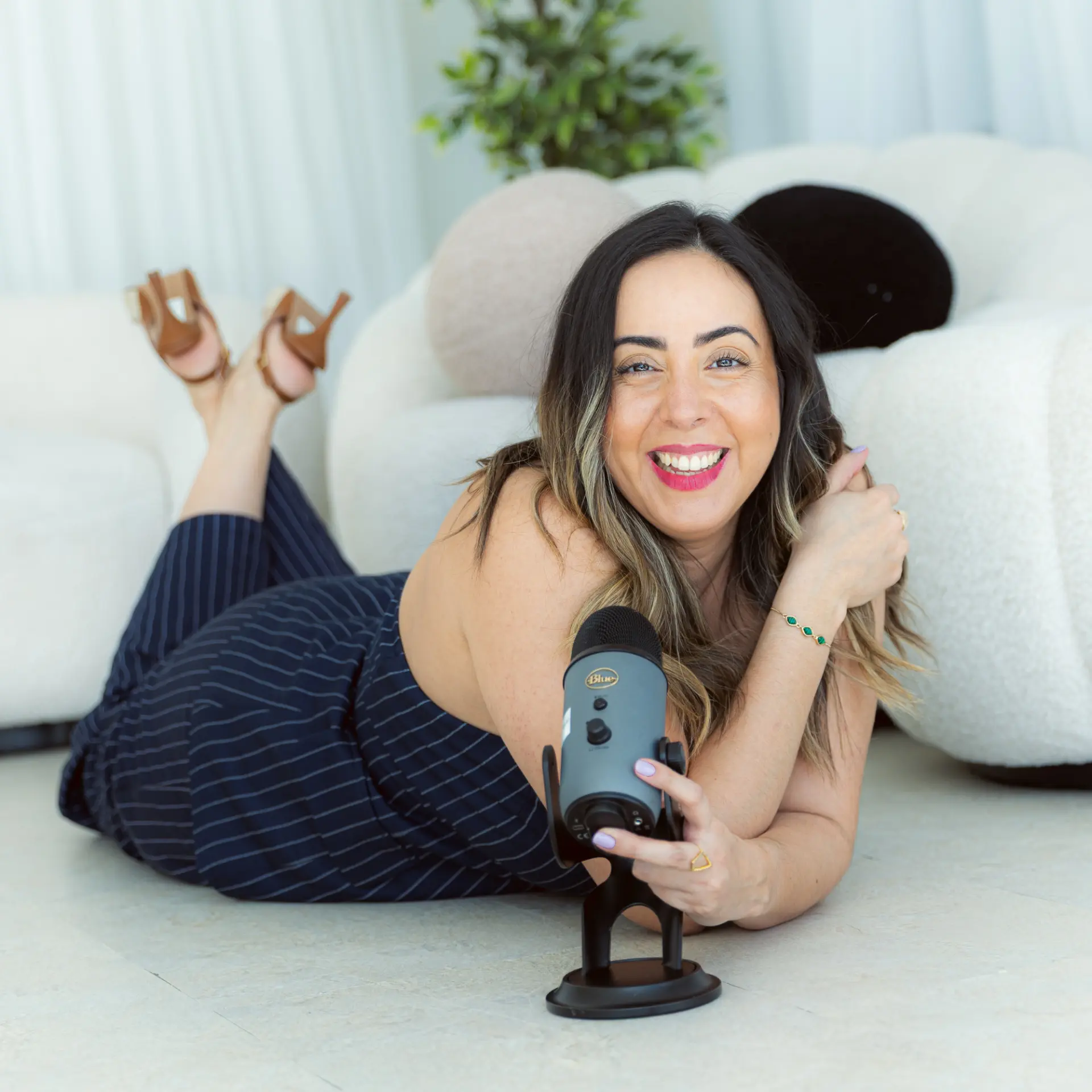 Martha Lucía smiling with her podcast microphone